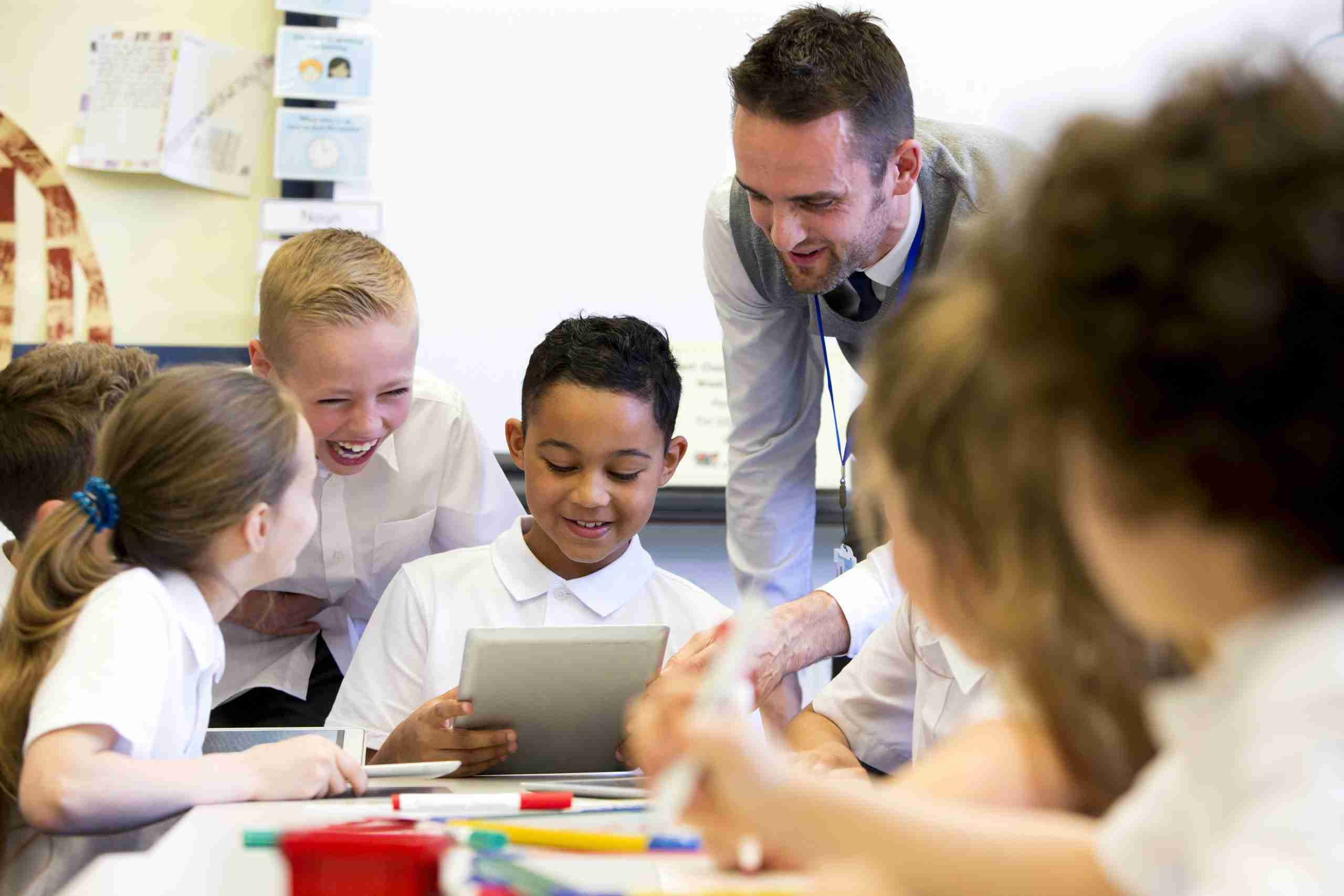 What Classroom Walkthroughs Reveal Beyond the Data Principal conducting a classroom walkthrough while observing students engaged in literacy instruction and reviewing instructional practices.