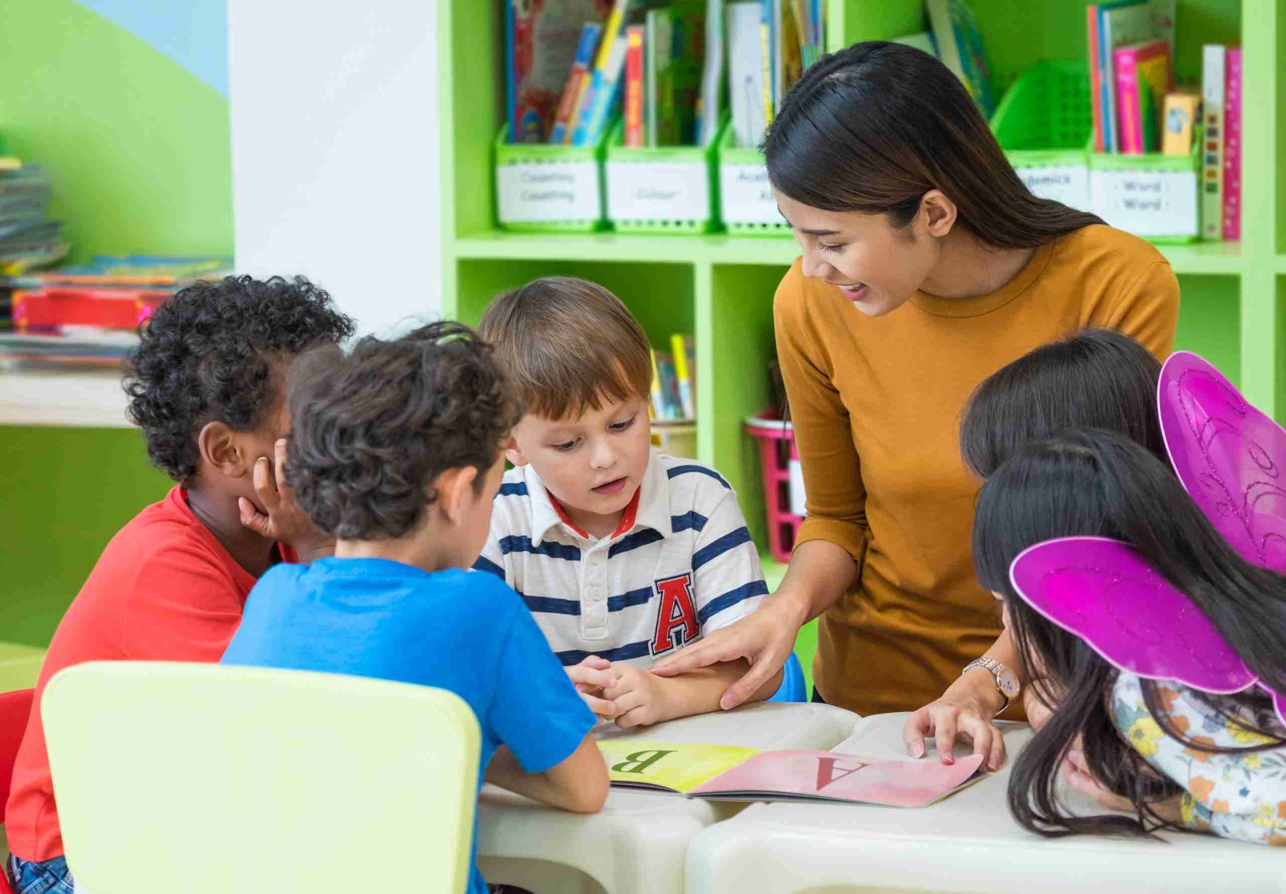 Special Education Is a Promise of Specialized Instruction Special education teacher providing individualized reading instruction to a student while reviewing IEP goals and progress monitoring data.